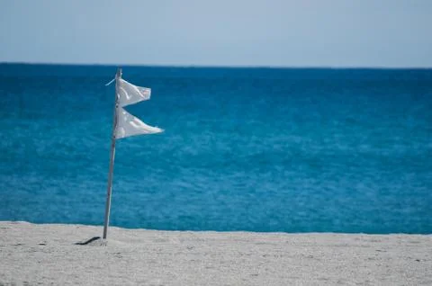 White flags on a Florida beach Stock Photos