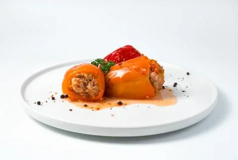 White flat dish with stuffed bell pepper. Stock Photos