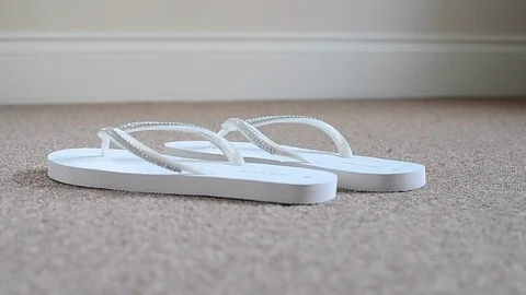 White flip flops on the carpet floor Stock Footage 94407216
