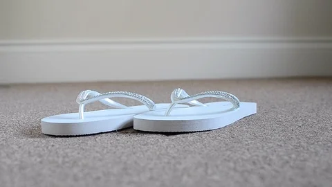 White flip flops on the carpet Stock Footage 94407227