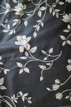 White floral pattern on black fabric with leaves and flowers Stock Photos