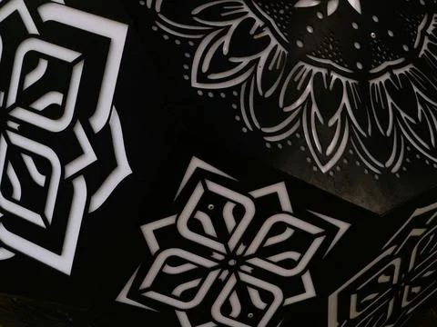 White floral patterns on black background with geometric designs Stock Photos