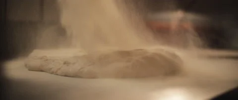 White flour is being spread over a fresh unprepared italian pizza dough. Stock Footage 146600475