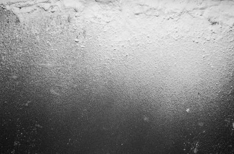 White flour on a black background, texture . Stock Photos