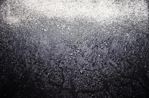 White flour on a black background, texture . Stock Photos