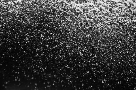 White flour on a black background, texture . Stock Photos
