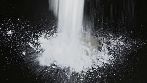 White flour falling on a table in bw Stock Footage 105292607