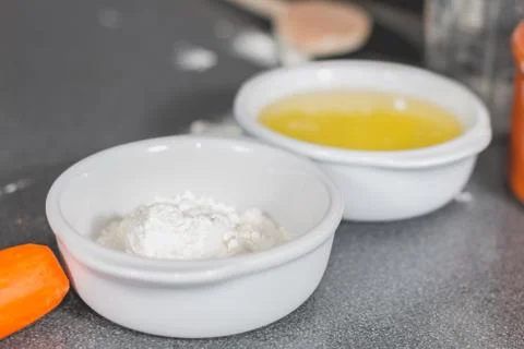 White flour in a ramekin on the kitchen worktop Stock Photos