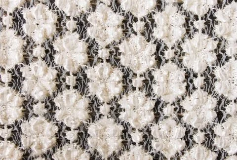 White Flower Knitting Pattern on Black Fabric Texture Background Stock Photos