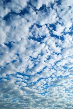 White, fluffy altocumulus clouds on a clean, blue summer sky. Photos