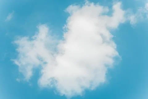 White fluffy cloud against light blue sky Stock Photos