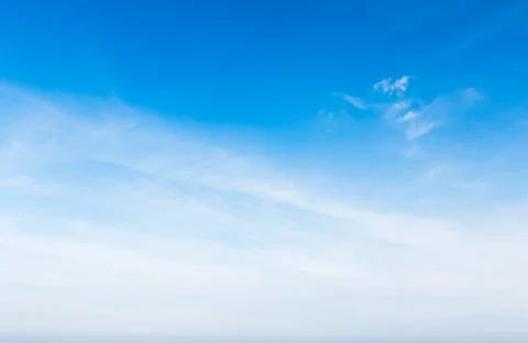 White fluffy cloud in the blue sky Stock Photos