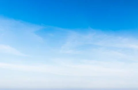 White fluffy cloud in the blue sky Stock Photos