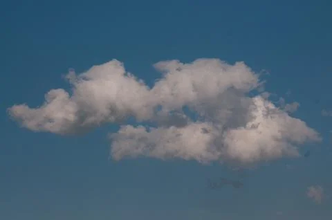 White fluffy cloud in a clear blue sky Stock Photos