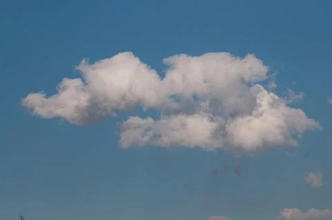 White fluffy cloud in a clear blue sky 写真素材