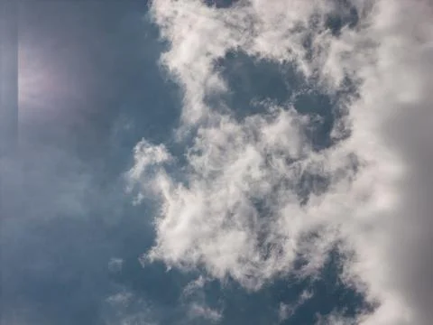 White fluffy cloud floating in clear blue sky Stock Photos