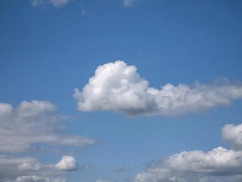 White fluffy cloud over blue summer sky background Stock Photos