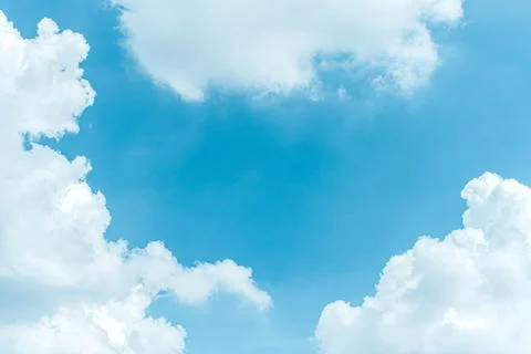 White fluffy clouds against blue sky in summer Stock Photos