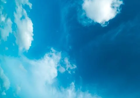 White fluffy clouds against blue sky in summer Stock Photos