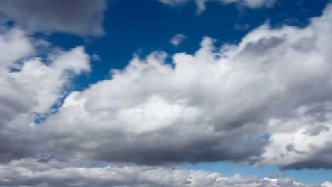 White fluffy clouds and blue sky time lapse Stock Footage 77794576