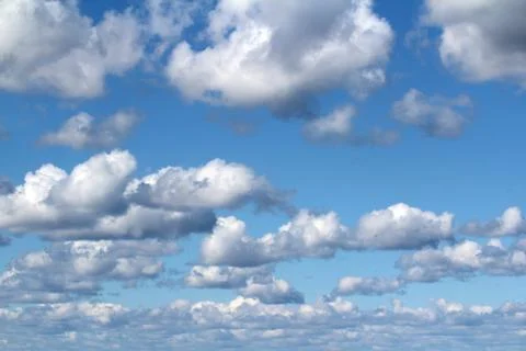 White fluffy clouds on a background of blue sky in summer. The concept of Stock Photos