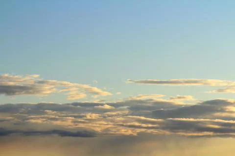 White fluffy clouds on a background of blue sky in summer. The concept of Stock Photos
