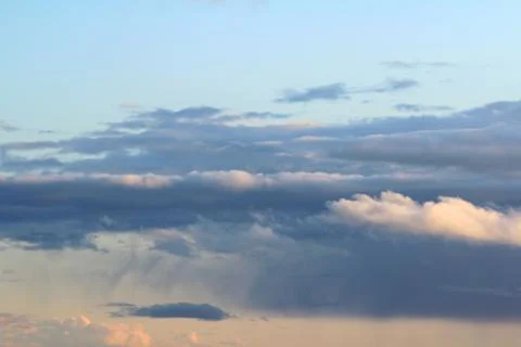 White fluffy clouds on a background of blue sky in summer. The concept of Stock Photos