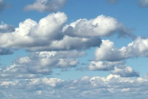 White fluffy clouds on a background of blue sky in summer. The concept of Stock Photos