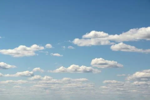 White fluffy clouds on a background of blue sky in summer. The concept of Stock Photos