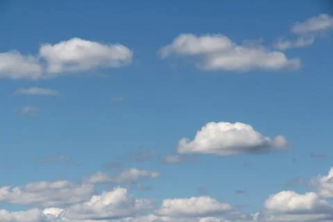 White fluffy clouds on a background of blue sky in summer. The concept of Stock Photos