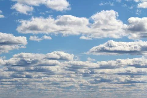 White fluffy clouds on a background of blue sky in summer. The concept of Stock Photos