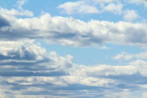 White fluffy clouds on a background of blue sky in summer. The concept of Stock Photos