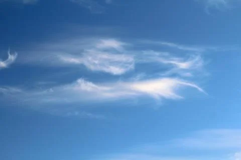 White fluffy clouds on a background of blue sky in summer. The concept of Stock Photos
