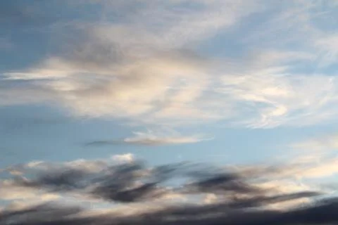 White fluffy clouds on a background of blue sky in summer. The concept of Stock Photos