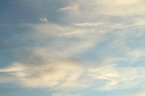 White fluffy clouds on a background of blue sky in summer. The concept of Stock Photos