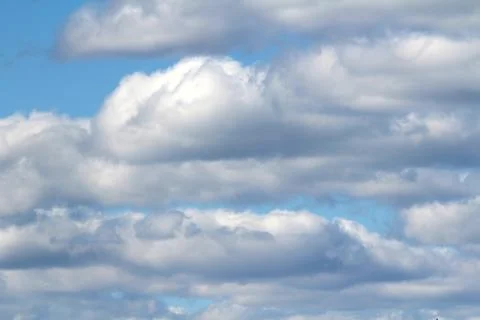 White fluffy clouds on a background of blue sky in summer. The concept of Stock Photos