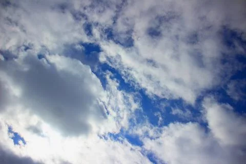 White fluffy clouds on a background of blue sky. Stock Photos