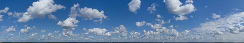 White fluffy clouds on a background of blue sky. Panorama of the sky Stock Photos