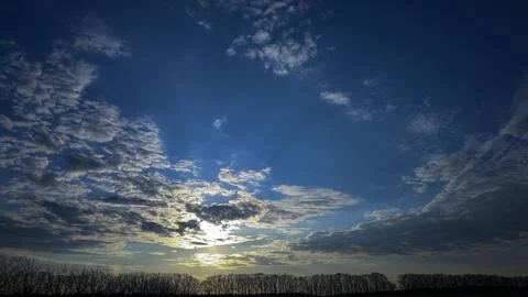 White fluffy clouds on the background of the sunset Stock Photos
