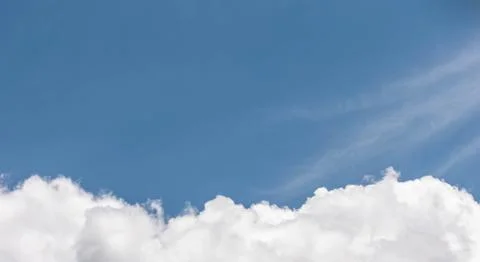 White fluffy clouds on a blue background with a place to write over them. 스톡 사진