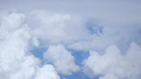 White fluffy clouds on a blue sky, view from above. Stock Footage 310951053