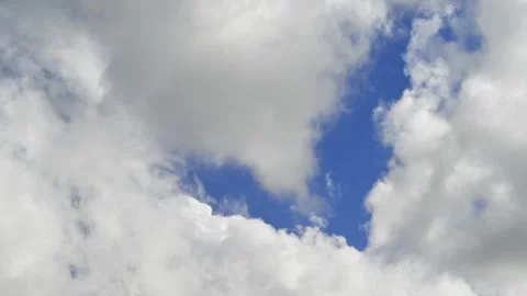 White fluffy clouds, blue sky, dreamlike skyscape, Seamless looping timelapse Stock Footage 318107447