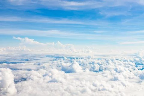 White fluffy clouds in the blue sky Stock Photos