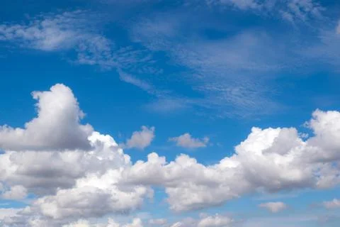 White fluffy clouds in the blue sky for background or backgrop nature concept Stock Photos