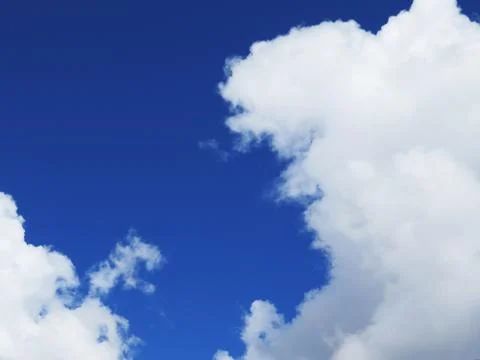 White fluffy clouds in the blue sky Stock Photos