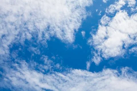 White fluffy clouds in the blue sky. Stock Photos