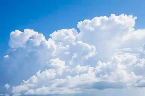 White fluffy clouds in the blue sky. Stock Photos