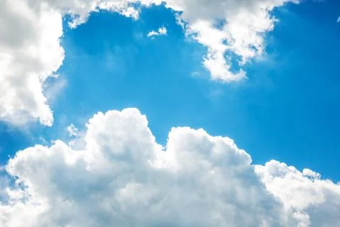White fluffy clouds in the blue sky Stock Photos
