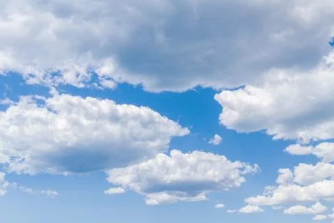 White fluffy clouds in the blue sky in summer Stock Photos