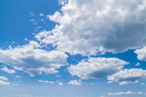 White fluffy clouds in the blue sky in summer Stock Photos